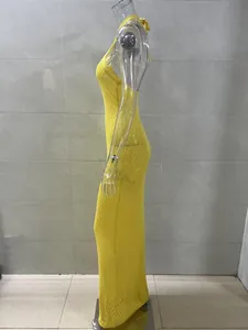 Side view of a yellow knitted halter beach maxi dress showing net texture