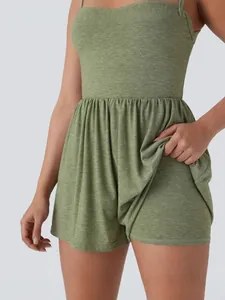 Women's sleeveless green romper jumpsuit featuring a pleated waist and skort design