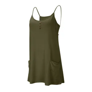 Close-up of olive green spaghetti strap dress with button detail and front pockets.