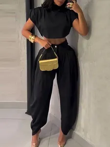 Elegant black two-piece fashion set for women featuring high waist trousers and crop top