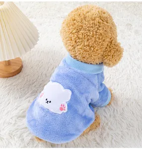 Macro detail of soft blue fleece pet sweater featuring a cute white bear applique design