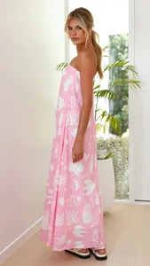 Full-length side view of a stylish pink tube top maxi dress with white graphic prints