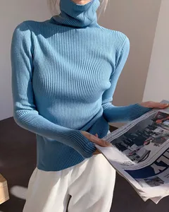 Detailed view of light blue ribbed turtleneck sweater with thumbhole cuffs