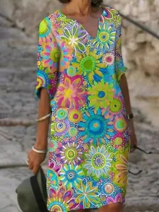 Close-up detail of vibrant abstract floral pattern on V-neck summer shift dress