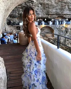Side view detail of a tiered blue floral chiffon maxi dress with backless camisole design
