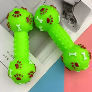 Close-up of green vinyl dog squeaky dumbbell toy featuring textured grip and paw patterns