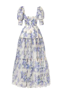 Detail view of the back of a blue floral organza maxi dress with lace-up design.