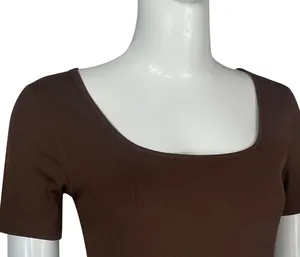 Detail view of a brown ribbed short-sleeve yoga bodysuit featured on a white mannequin