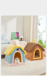 Cozy indoor home setting featuring two colorful closed cat houses and a kitten inside
