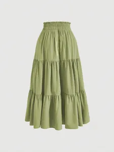 Detailed view of sage green plus size tiered midi skirt featuring an elastic waist