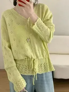 Close-up of lime green hollow-out knitted cardigan with drawstring waist detail