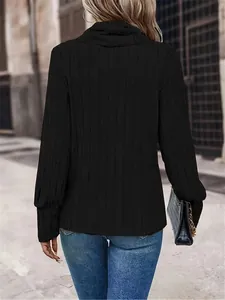 Back view of elegant black ribbed high neck long sleeve top for women in urban street