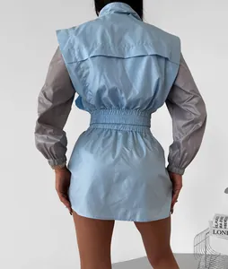 Detailed back view of women's stylish blue and grey color-block windbreaker set