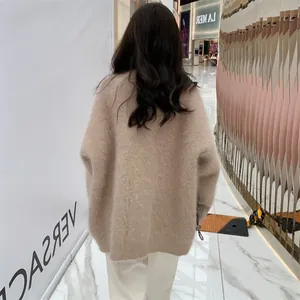 Back view showing the loose fit of a soft beige faux mink fur oversized cardigan for women