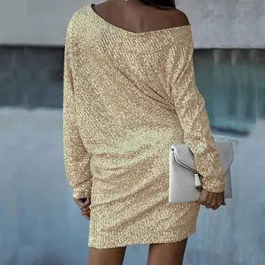 Close-up back detail view of a gold sequined asymmetrical off-shoulder mini party dress