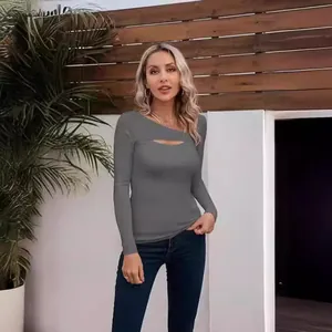 Close-up of woman wearing a grey slim-fit T-shirt with irregular cut-out neckline.