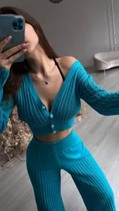 Detail view of a women's blue hollow-out knitted two-piece set with high-waist flared pants