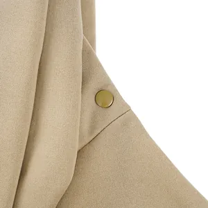 Close-up detail of khaki fabric texture and snap button on portable pet carrier bag