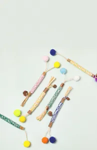Macro view of various colorful cat matatabi chew sticks with raffia and pom-poms
