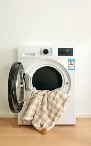Close-up detail of machine-washable checkered pet blanket with cute puppy patterns for dogs and cats