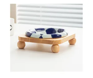 Detail view of checkerboard ceramic pet bowl with a minimalist oak wood stand.