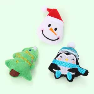 Christmas cat toys set with plush snowman, tree, and penguin on light green background