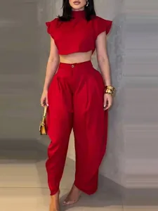 Chic red high-waisted trousers and sleeveless crop top two-piece outfit set.