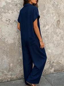 Back view of a navy blue casual loose short sleeve jumpsuit featuring functional pockets