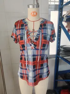 Close-up detail of women's plaid print slim fit top featuring front lace-up V-neck design