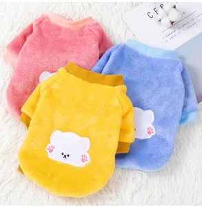 Detailed view of soft fleece pet sweaters in pink blue and yellow with cute bear patches