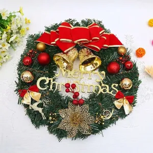 Large Christmas wreath with red bow and Merry Christmas sign for front door decor.