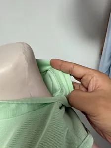 Detail view showing inner neck seam and ribbed knit fabric of mint green vest