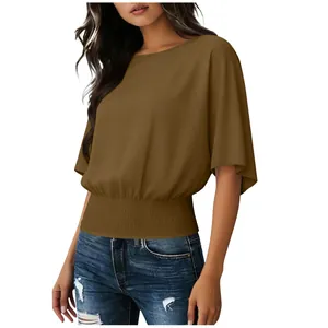 Detail view of women's brown short sleeve blouse with smocked waist and round neck
