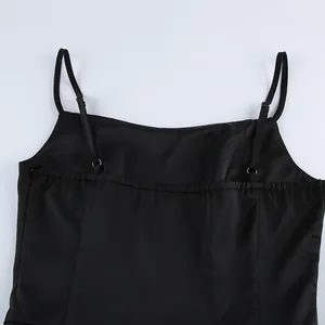 Close-up of black satin camisole featuring adjustable straps and elastic back detail