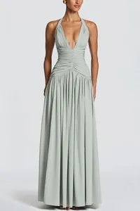 Full view of elegant sage green deep V halter maxi dress with ruched waist detail