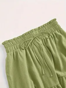 Macro close-up detail of green tiered skirt with elastic paperbag waist and drawstring