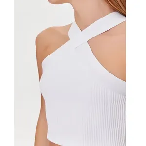 Detail view of white cross halter neck knitted crop top showing fine ribbed texture