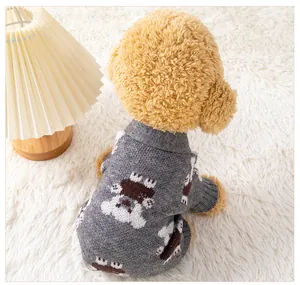 Back view detail of grey knitted pet sweater with cartoon bear patterns on white rug