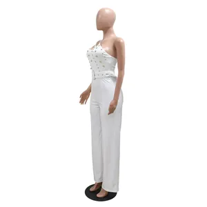 Full length side view of a white one-shoulder slim-fit jumpsuit with gold stud details