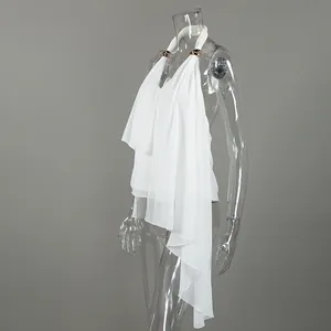 Side view of an elegant white chiffon halter top with asymmetrical drapes and gold hardware.