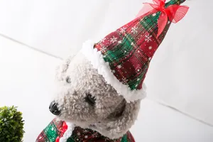 Detail of pet Christmas plaid hat and cape with snowflake pattern for dogs and cats.