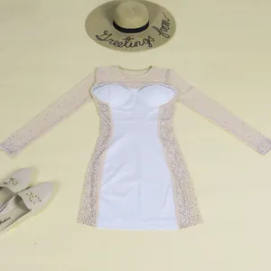 Detail showing sheer rhinestone mesh sleeves on this white slim-fit dress