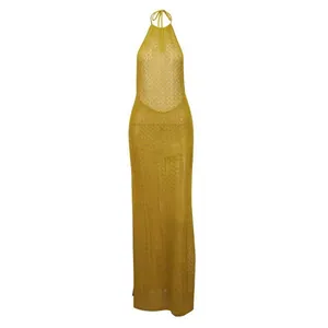Detail view of a mustard yellow knitted halter maxi dress with hollow-out pattern.