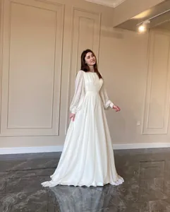 Elegant white pearlescent chiffon wedding dress with lantern sleeves and round neck.