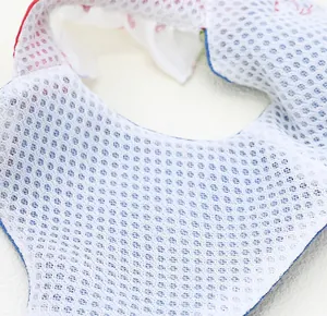 Macro view showing the breathable white mesh fabric lining of a small pet harness dress