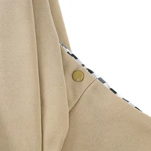Close-up detail of khaki pet carrier bag showing snap button and checkered lining.