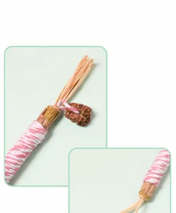 Macro detail of natural silvervine stick with gall fruit and raffia cat teething toy