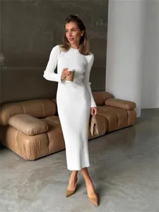 Elegant white ribbed knit long-sleeved maxi dress for women in a chic lifestyle setting