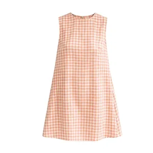 Front view of sleeveless peach gingham dress with round neckline and casual A-line cut