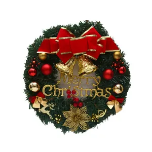 Festive Christmas wreath with red bow and gold Merry Christmas sign for holiday door decor